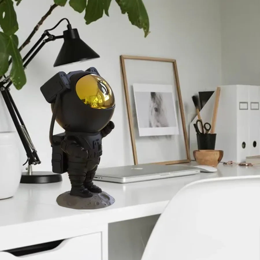 Bluetooth speaker with LED star projector displaying blue galaxy lights in a dark room with smartphone control